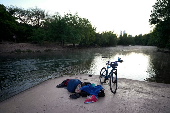 Harold Hicks, who is homeless, sleeps at the Barton Springs spillway, Friday, April 12 in Austin. (Credit: Jay Janner/American-Statesman)