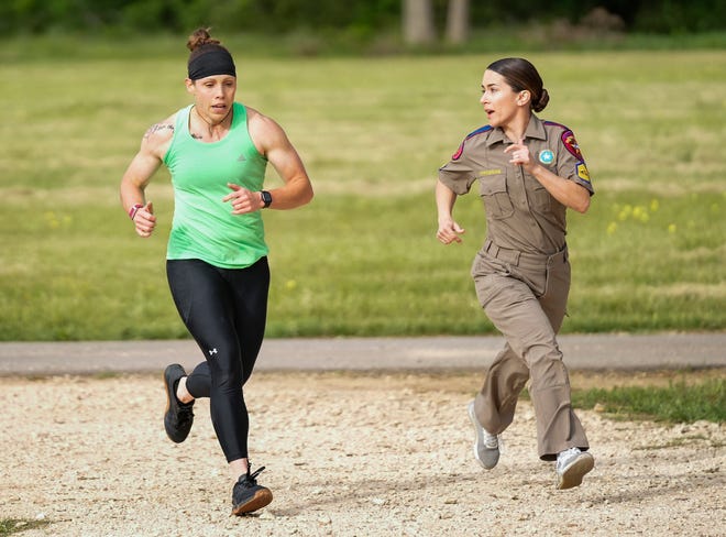 Department of Public Safety Sgt. Amanda Epperson, right, encourages Trooper Dani Basye as she competes in the physical fitness contest at the 12th Annual Top Trooper Competition at the DPS Tactical Training Center in Florence Tuesday April 23, 2024. The weeklong event has 120 troopers competing in physical fitness, driving and firearms skills, and job knowledge. The male and female winners will earn the Javier Arana, Jr. Top Trooper Award, named after fallen Trooper Javier Arana, Jr., who participated in the inaugural competition, and get a new patrol vehicle.