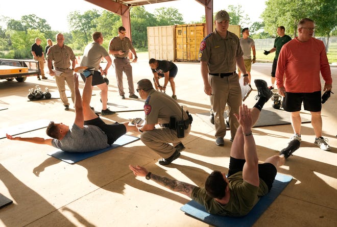 Department of Public Safety troopers compete in the physical fitness contest at the 12th Annual Top Trooper Competition at the DPS Tactical Training Center in Florence Tuesday April 23, 2024. The weeklong event has 120 troopers competing in physical fitness, driving and firearms skills, and job knowledge. The male and female winners will earn the Javier Arana, Jr. Top Trooper Award, named after fallen Trooper Javier Arana, Jr., who participated in the inaugural competition, and get a new patrol vehicle.