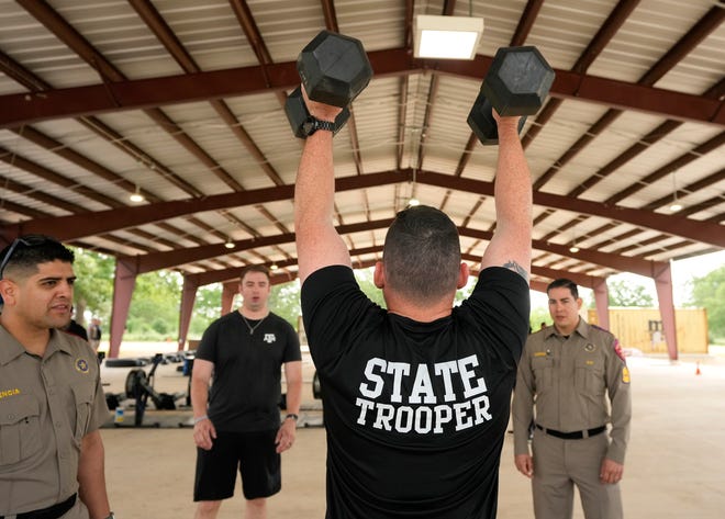 Department of Public Safety Trooper Jason Tye competes in the physical fitness contest at the 12th Annual Top Trooper Competition at the DPS Tactical Training Center in Florence Tuesday April 23, 2024. The weeklong event has 120 troopers competing in physical fitness, driving and firearms skills, and job knowledge. The male and female winners will earn the Javier Arana, Jr. Top Trooper Award, named after fallen Trooper Javier Arana, Jr., who participated in the inaugural competition, and get a new patrol vehicle.